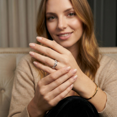Lifestyle image of a woman wearing the stackable double layer wavy moissanite ring, showcasing the elegant finger coverage and bright white gold finish.