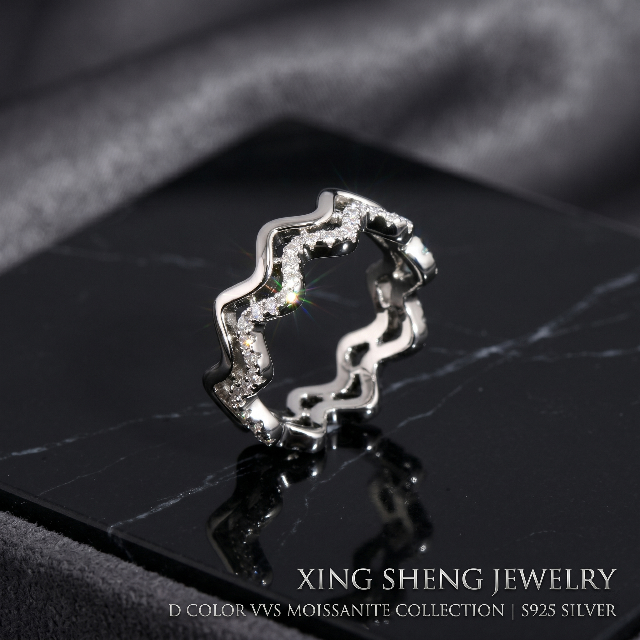 Front view of a brilliant 6A quality round moissanite double layer wavy stacking ring set in rhodium-plated S925 sterling silver, resting on a black marble display.
