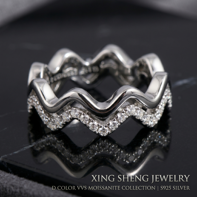 Extreme macro photography detailing the impeccable VVS clarity and fiery brilliance of the top-quality round moissanite stones set in the double layer band.