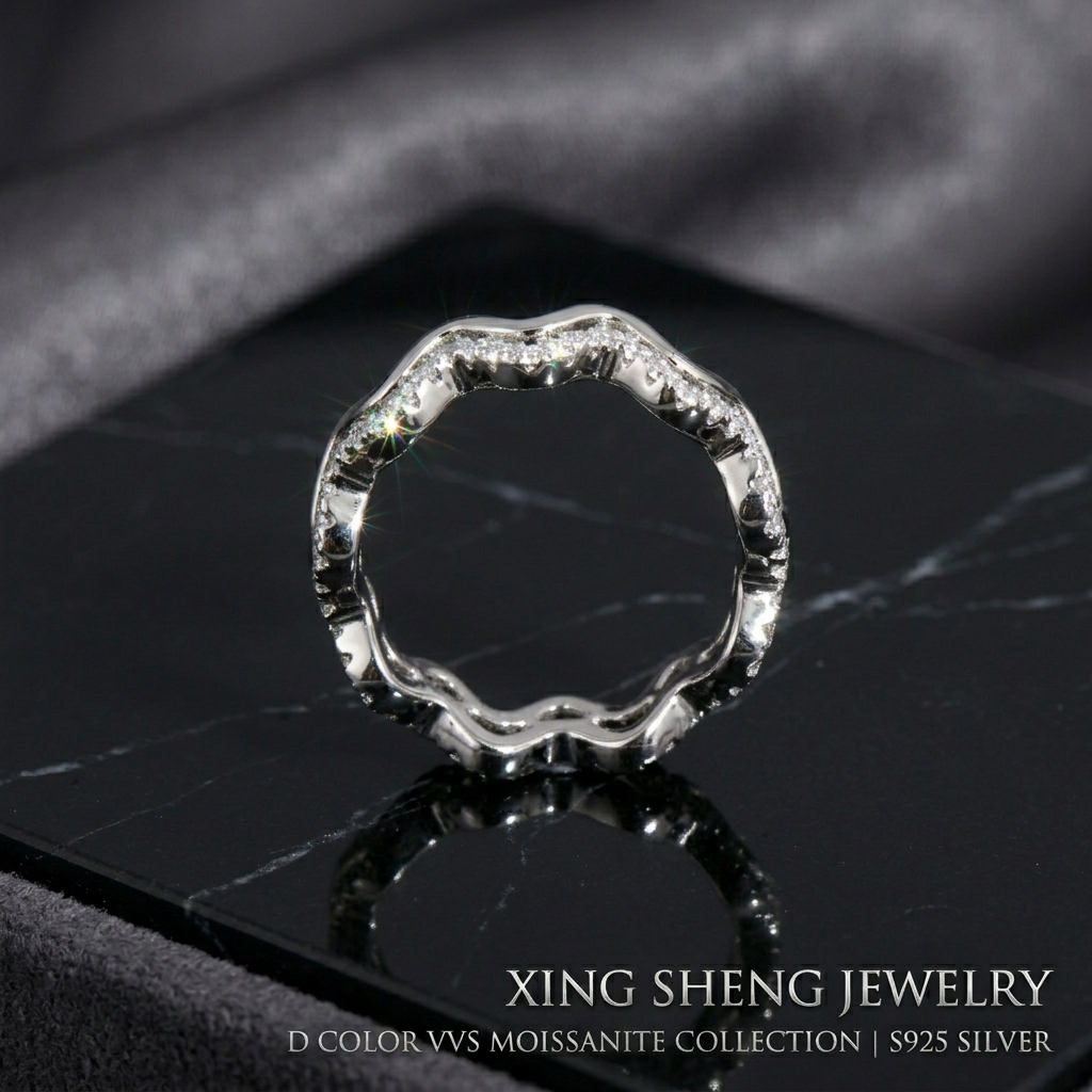 Macro close-up of the Excellent Cut VVS round moissanite stones securely micro-pave set into the flowing wavy band, demonstrating superior rainbow fire and brilliance.
