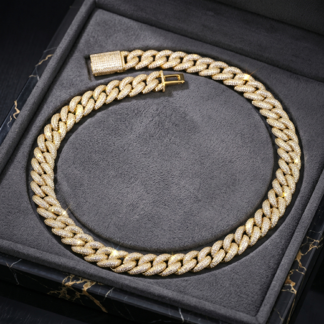 The heavy 16mm iced out moissanite Cuban chain in a stunning yellow gold finish, beautifully presented inside a dark luxury jewelry box, highlighting its high-end gift appeal.