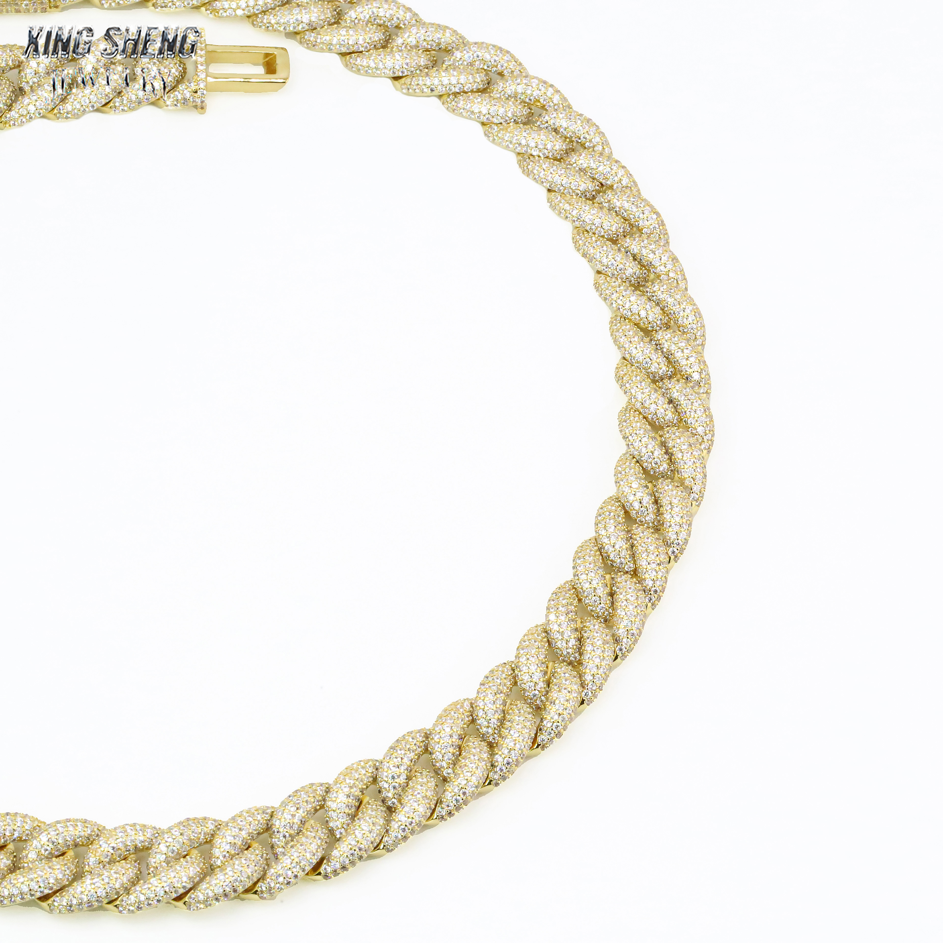 Close-up macro detail of Excellent cut 6A VVS moissanite stones hand-set in a 16mm gold Cuban link chain.