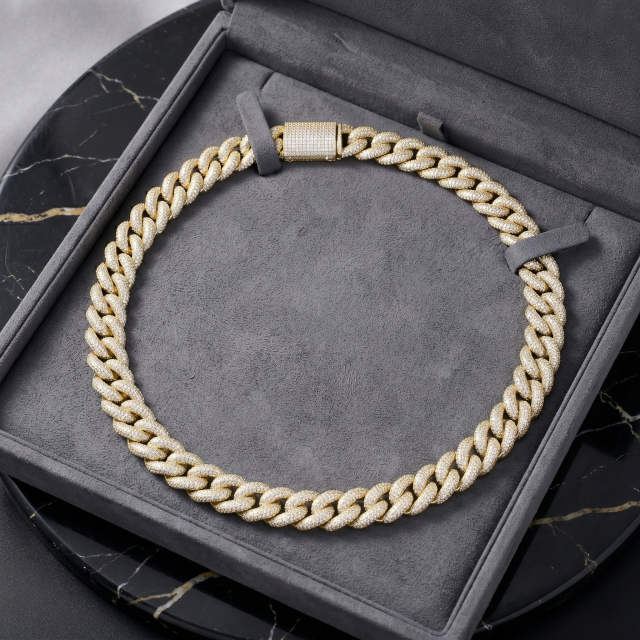 A luxurious 16mm gold moissanite Cuban link chain presented in a premium grey jewelry gift box reflecting bright light.