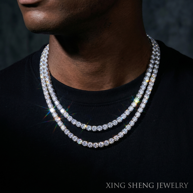 Male model wearing layered premium VVS moissanite tennis chain necklaces, showcasing the brilliant sparkle of 6A quality stones set in rhodium-plated silver.