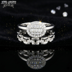 High brilliance straight baguette and round cut moissanite bridal set glowing on dark black velvet fabric.