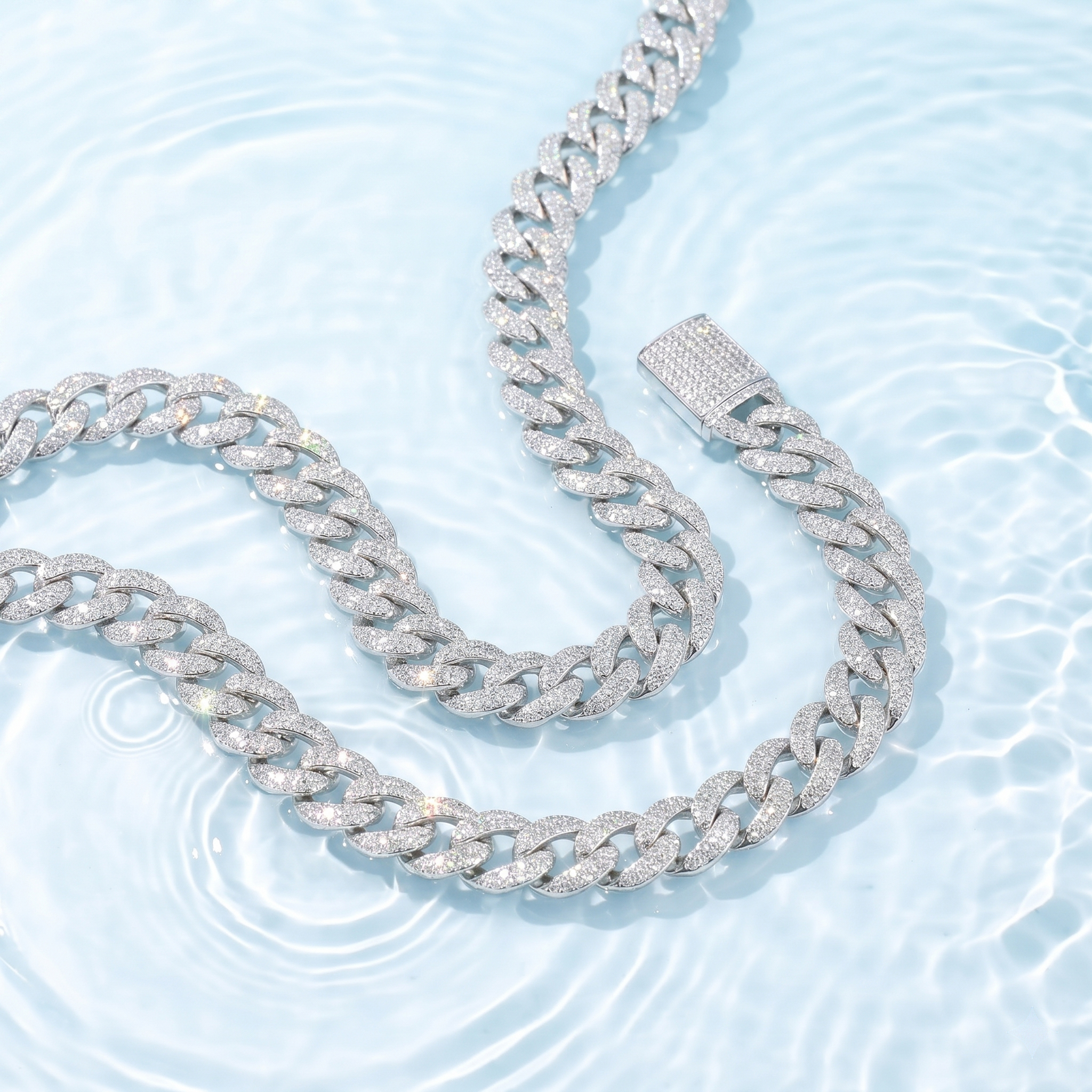 Close-up of the 13mm moissanite Cuban link chain in rhodium-plated S925 silver, showcasing its brilliant fire and anti-tarnish waterproof properties against a water background.