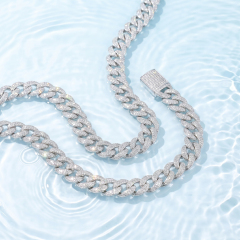 Close-up of the 13mm moissanite Cuban link chain in rhodium-plated S925 silver, showcasing its brilliant fire and anti-tarnish waterproof properties against a water background.
