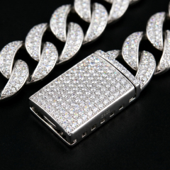 Macro photography of the secure, heavy-duty iced out box clasp on the 13mm S925 silver moissanite Cuban chain, featuring flawless micro-prong stone settings.