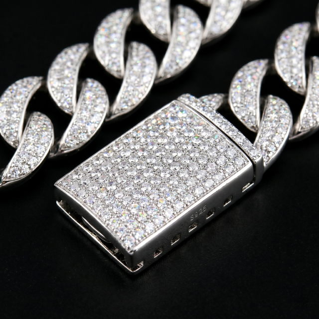 Macro photography of the secure, heavy-duty iced out box clasp on the 13mm S925 silver moissanite Cuban chain, featuring flawless micro-prong stone settings.