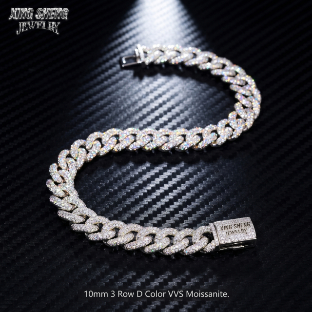 Perfectly aligned 10MM 3-row D Color VVS Moissanite Cuban link chain shaped in an S-curve on a dark carbon fiber background, highlighting the secure custom clasp.
