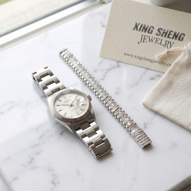 The 8mm baguette moissanite link bracelet styled gracefully next to a luxury watch, demonstrating premium lifestyle integration and daily wearability.