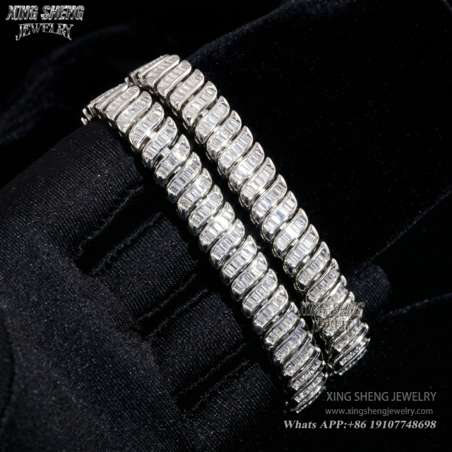 Two brilliant baguette cut moissanite bracelets draped over a black gloved hand, showcasing the intense light reflection and 6A quality fire.