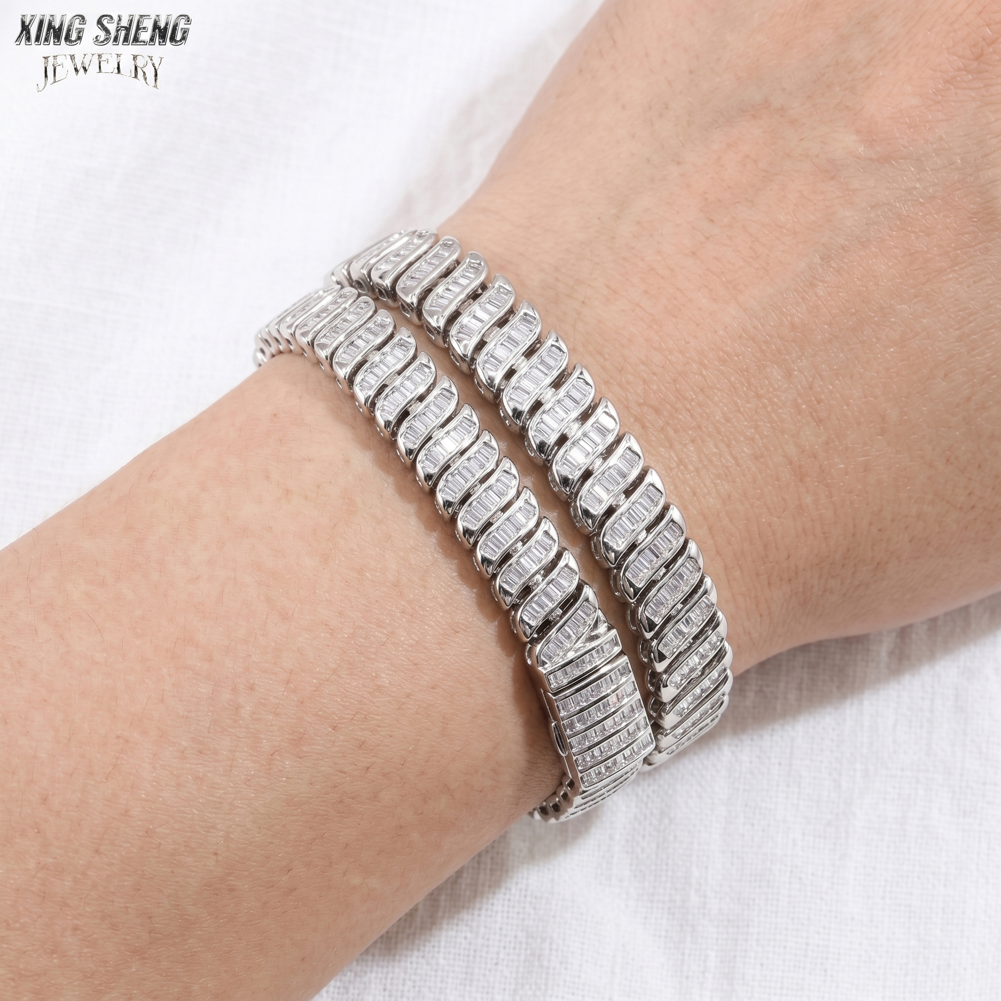 Lifestyle demonstration showing two 8mm baguette moissanite bracelets stacked on a wrist, featuring a versatile and bold unisex jewelry design.