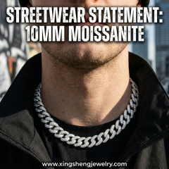 Male model showcasing modern streetwear fashion by wearing a heavy, iced-out 10mm moissanite Cuban link necklace, demonstrating the perfect collarbone drape and bold aesthetic.