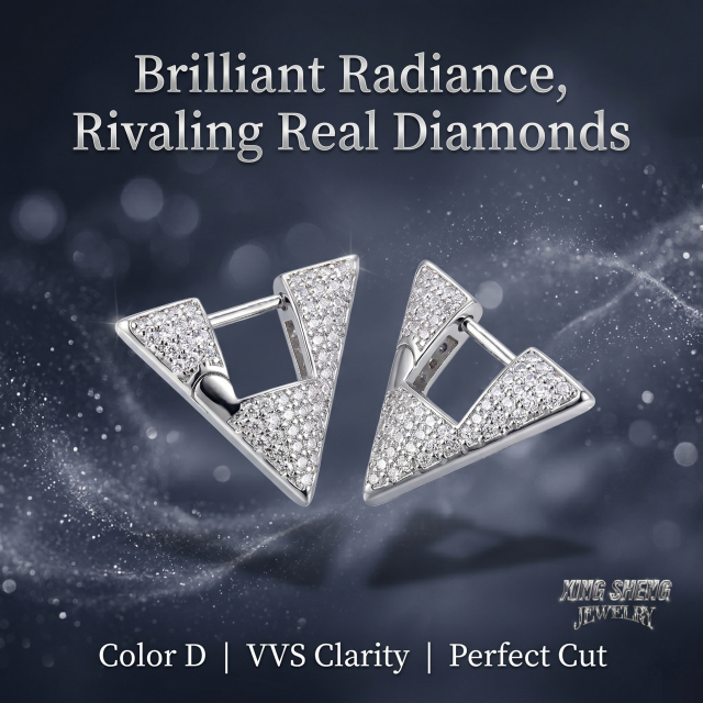 Close-up of VVS1 clarity brilliant-cut moissanite stones sparkling in a geometric sterling silver huggie setting, demonstrating perfect cut and radiance rivaling real natural diamonds.