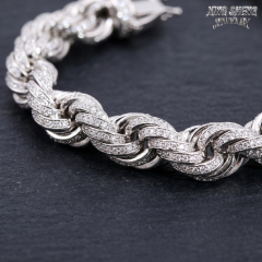Extreme macro photography of the interwoven silver links on the 10mm rope chain, showing the 360-degree pave stone setting.