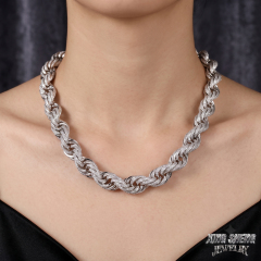 Female model showcasing the heavy 10mm iced out moissanite rope chain resting flawlessly across the collarbone.