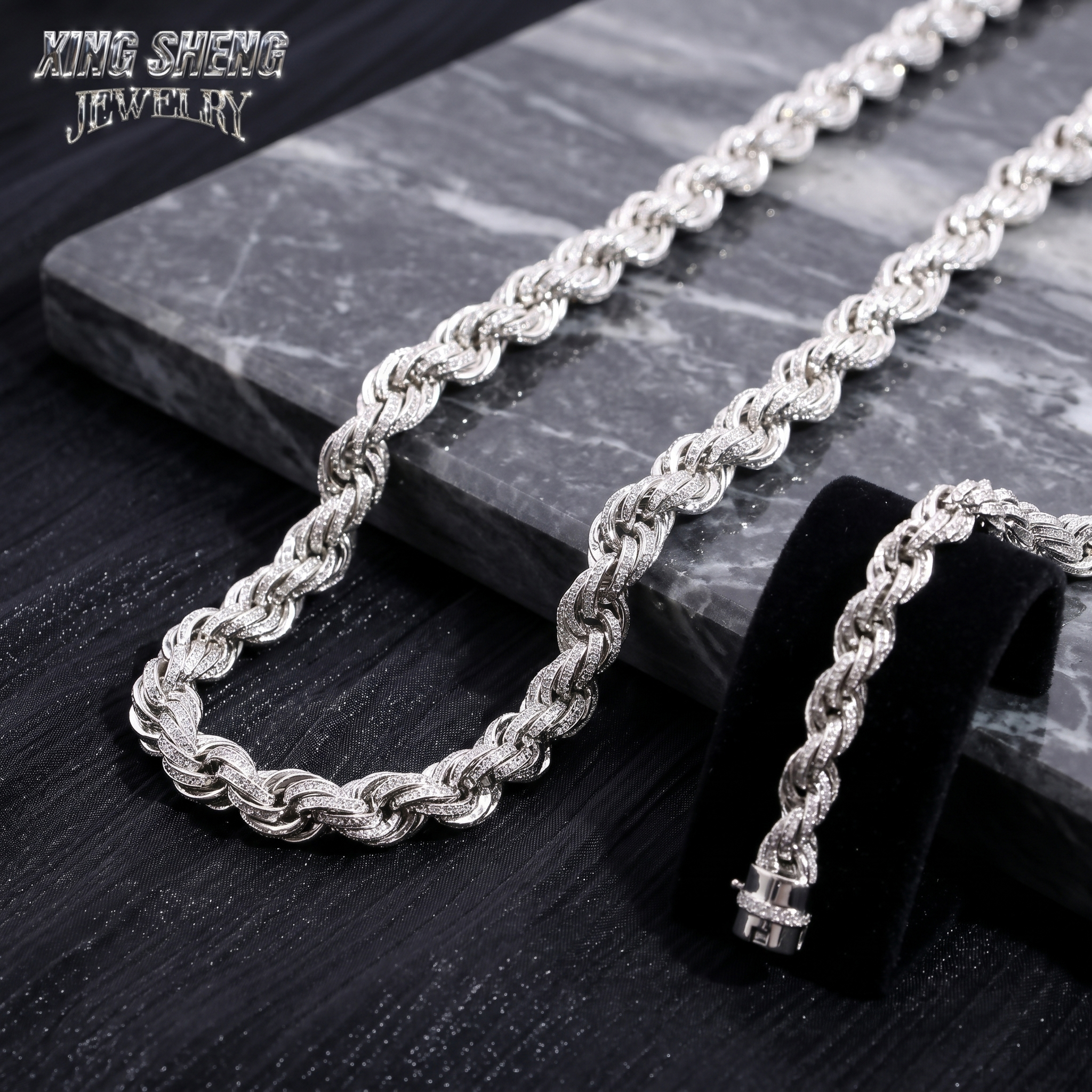 Macro close-up of excellent cut round moissanite stones meticulously set in a 10mm 3D rope chain architecture resting on black marble.