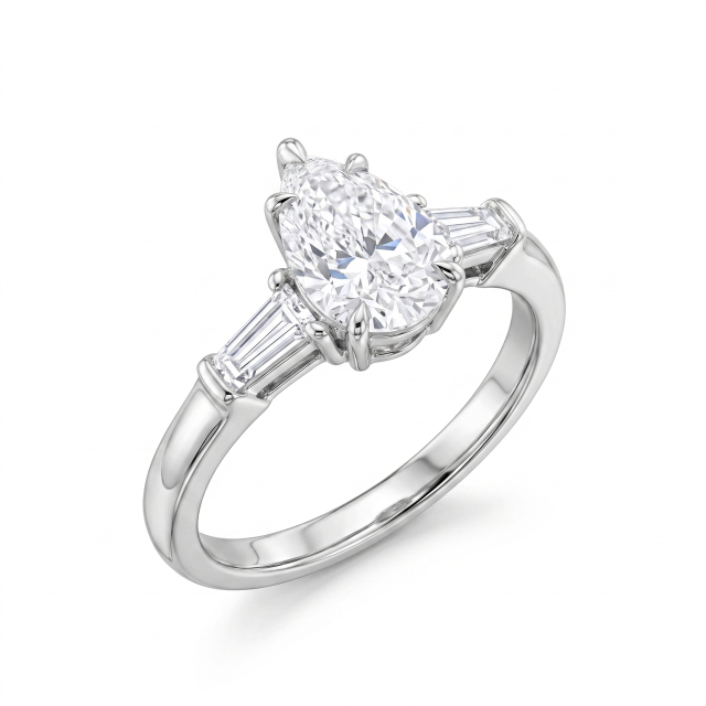 Angled studio profile of an 18K white gold three-stone ring highlighting the secure V-prong setting and step-cut trapezoid side diamonds.