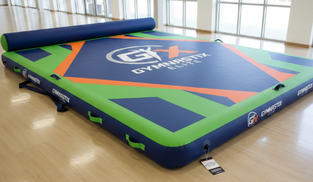 Customized gymnastic blow-up mats featuring personalized logo and color choices for branding