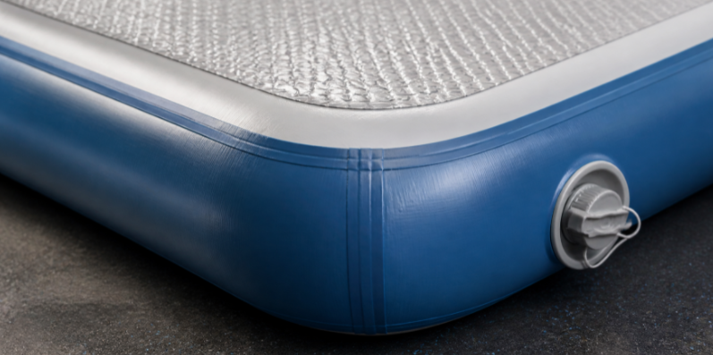 Close up of air track safety features including reinforced seams, secure valve, and non-slip surface