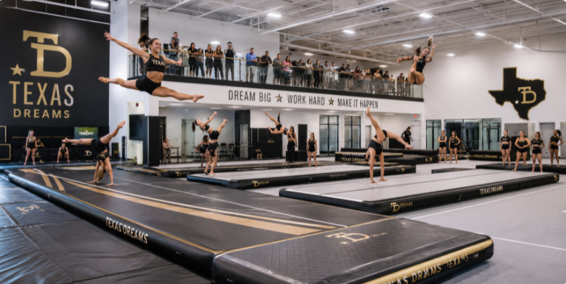 A fully upgraded commercial gymnastics academy showcasing a professional, unified layout of custom-branded training equipment.
