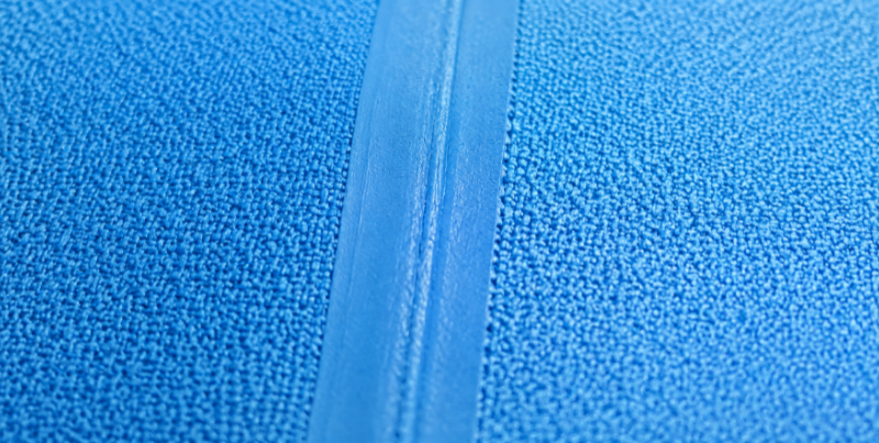 close-up of a heat welded seam on drop stitch PVC pool fabric showing mesh texture
