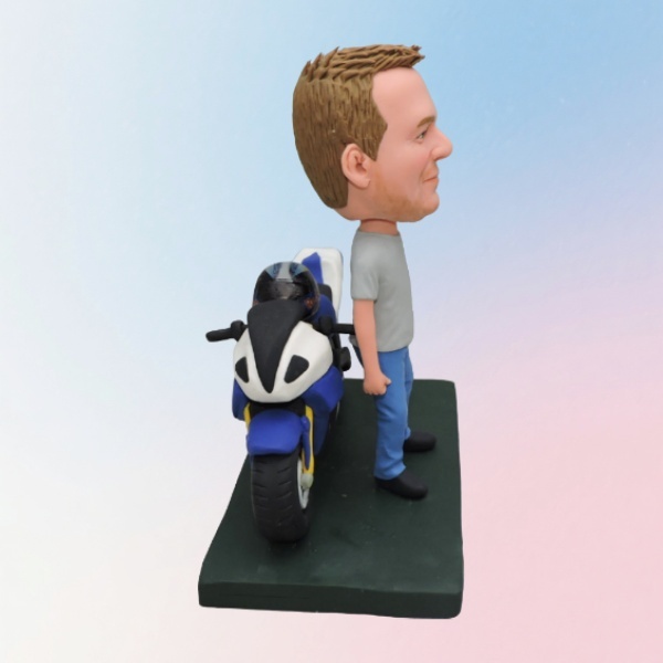 Customized bobblehead dolls standing beside motorcycles.