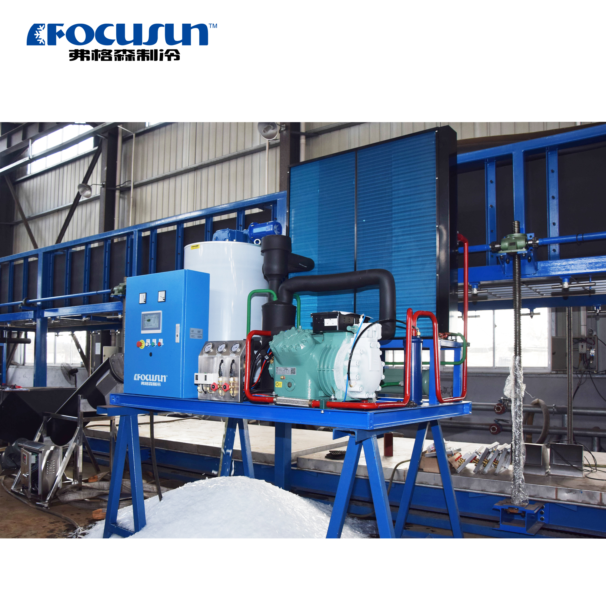 Hygienic industrial flake ice machine with a stainless steel evaporator drum for rapid seafood processing line cooling.