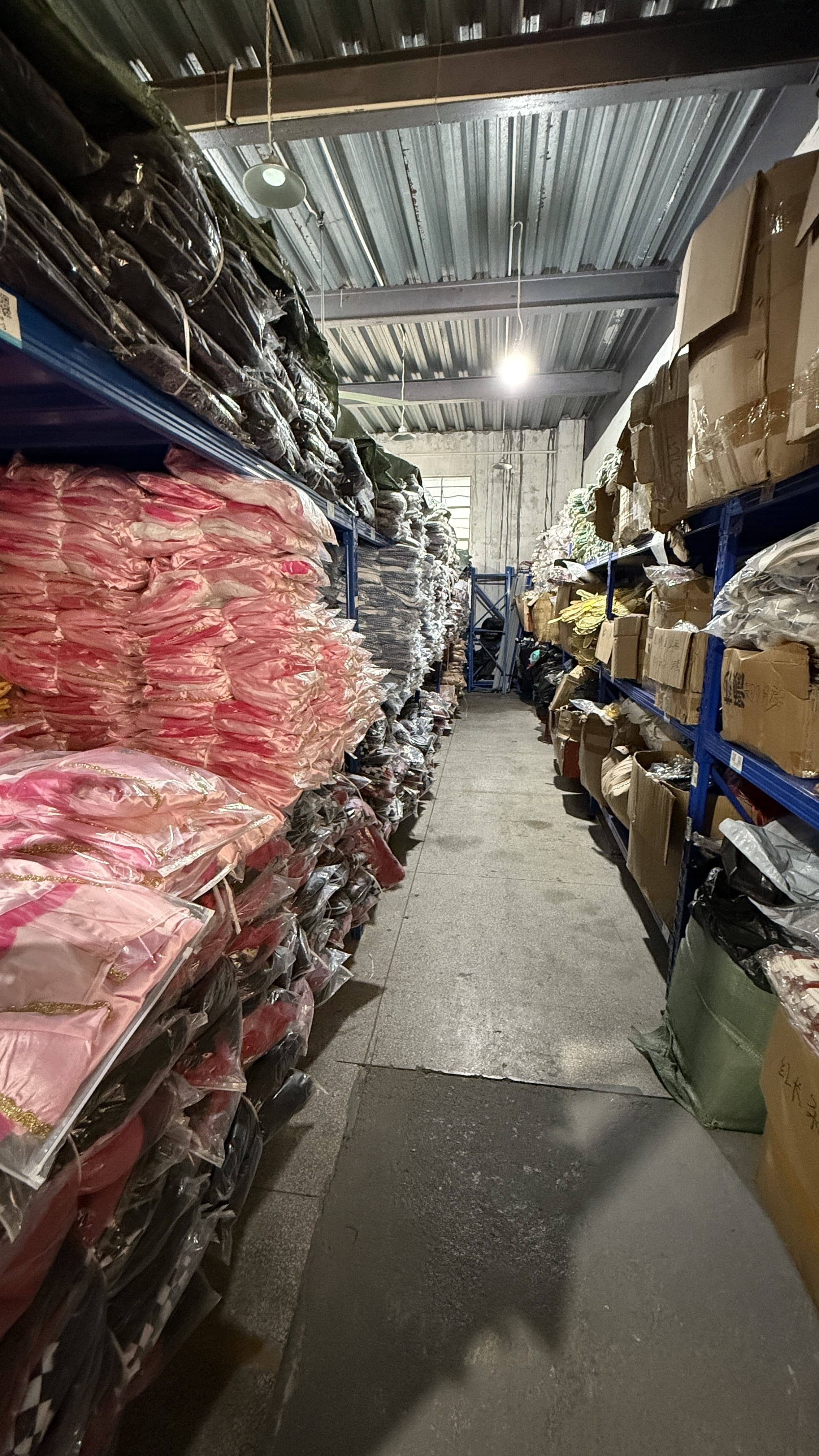 Wholesale costume supplier warehouse with stacked boxed and packaged seasonal costumes