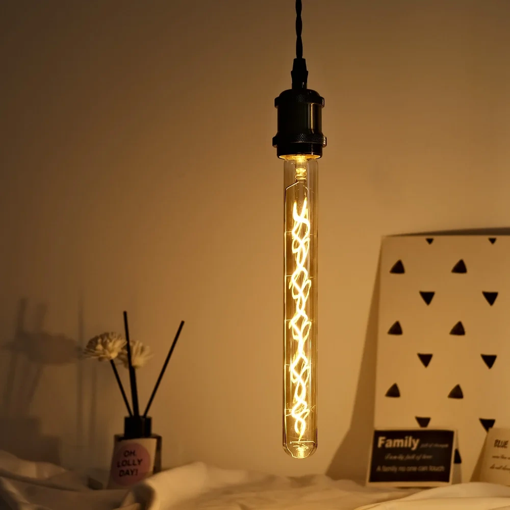 Vintage E27 filament bulb suspended from a black pendant holder