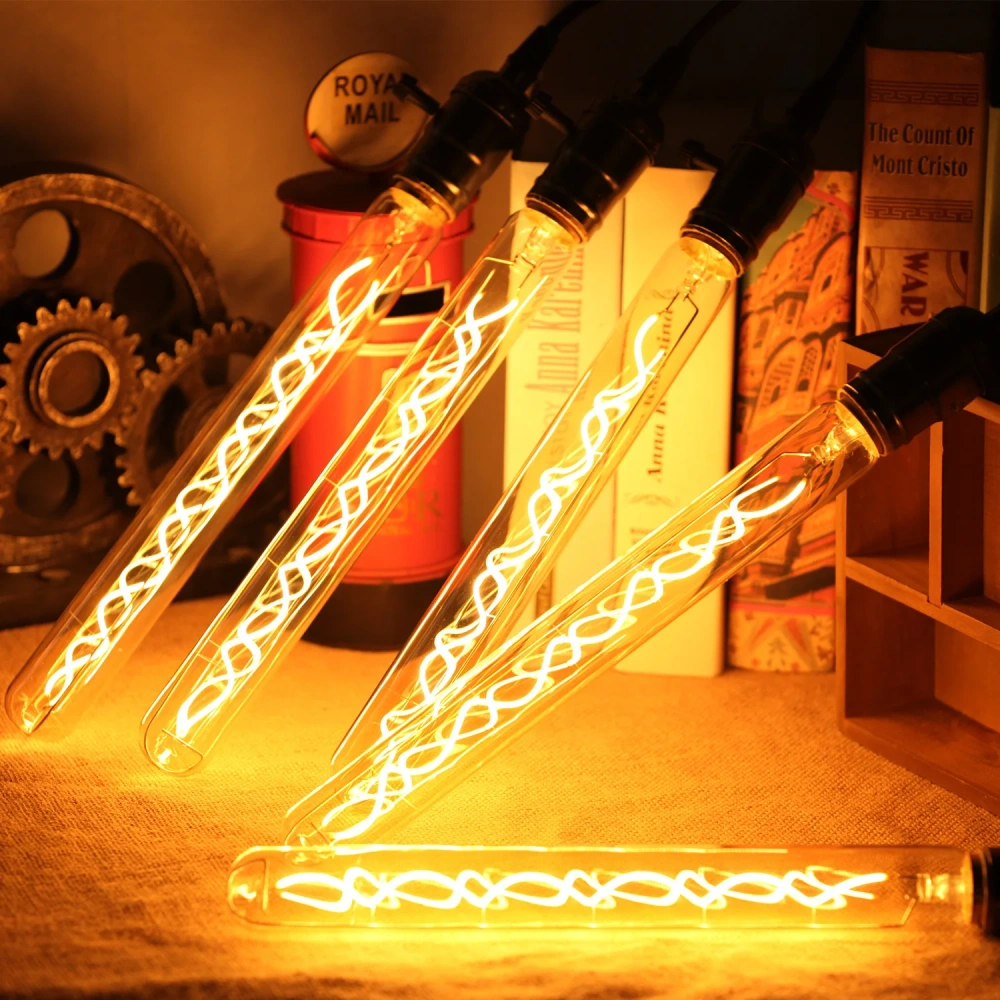 Illuminated tubular Edison bulbs with decorative curved filaments