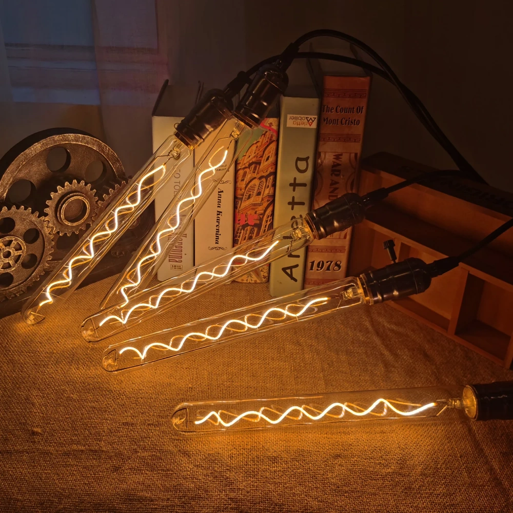 Long tube LED filament bulbs displayed beside books and a vintage telephone