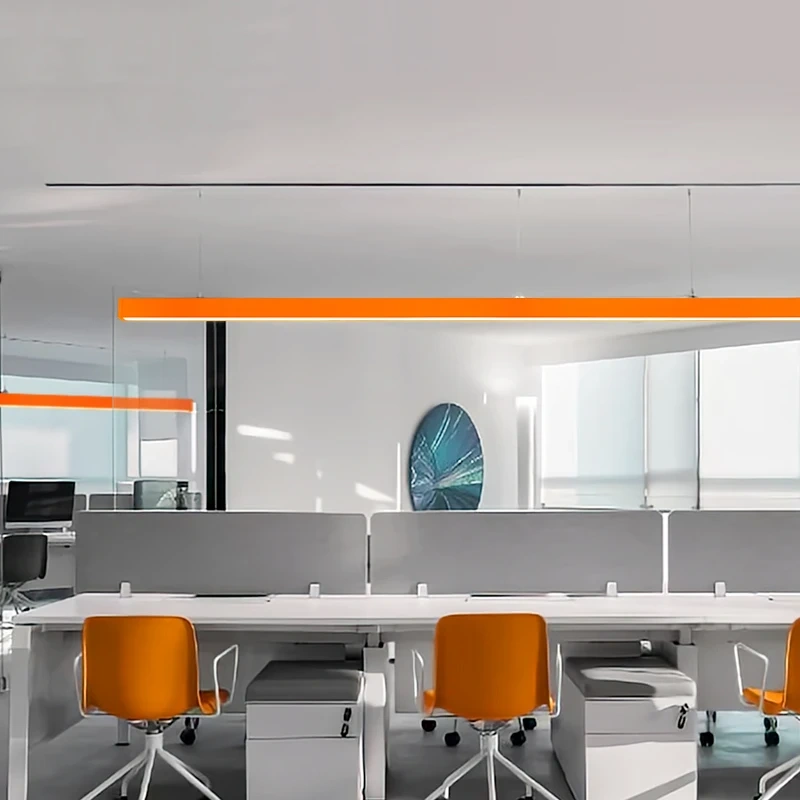 modern orange pendant light hanging over a white dining table