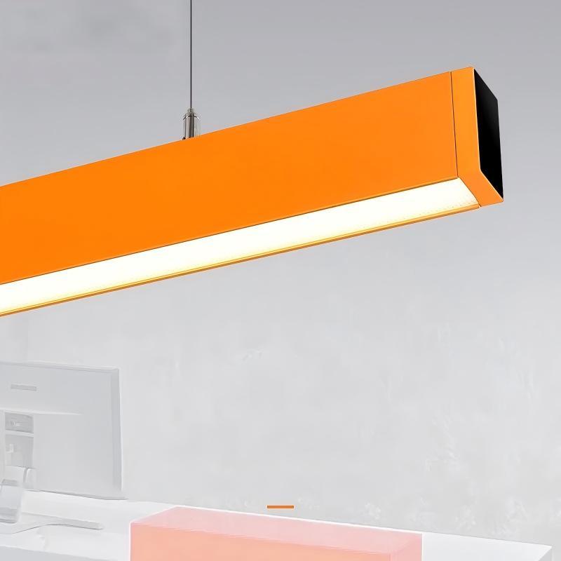 modern orange pendant light hanging over a white dining table