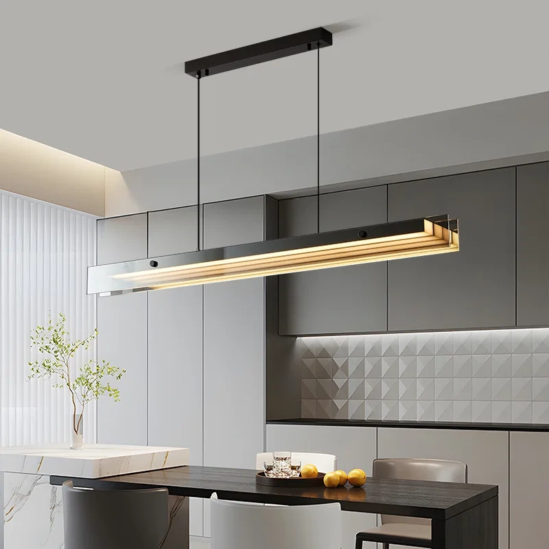 Minimalist LED linear pendant lamp hanging over a wooden dining table