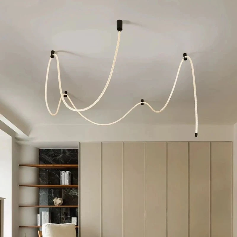 Illuminated rope chandelier forming curved lines beneath the ceiling
