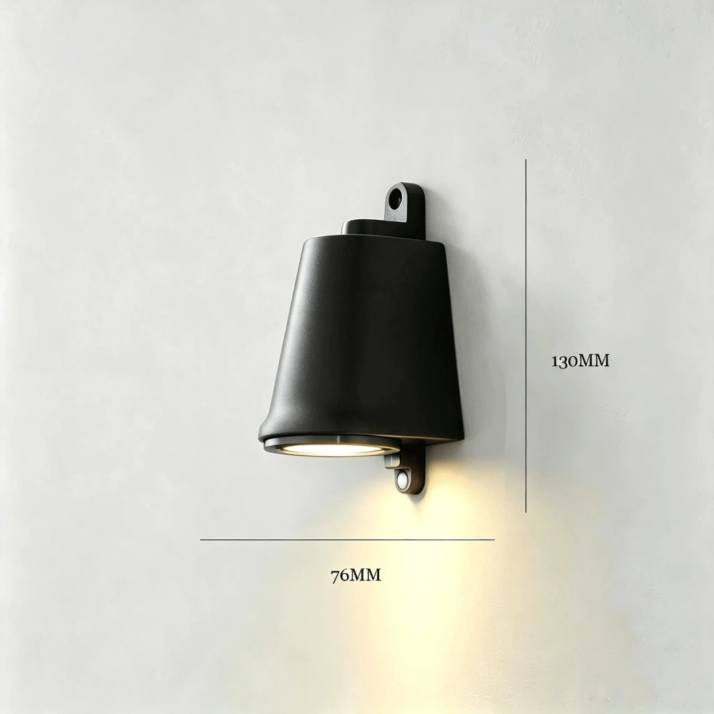 Black industrial outdoor wall light mounted on a tiled exterior wall