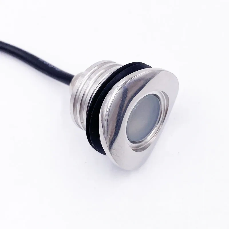 Close-up of recessed LED handrail light with curved stainless steel face