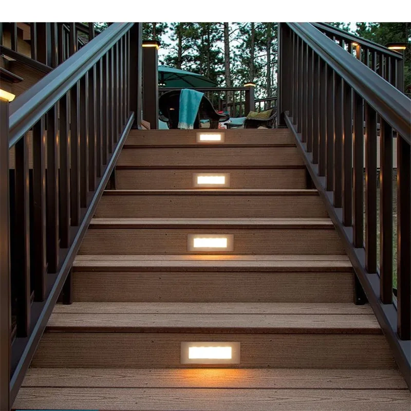 Rear view of an LED stair light with blue housing and cable entry