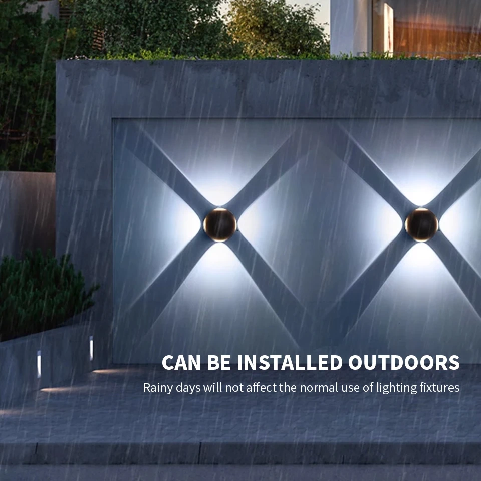 Two black LED wall lights casting cool white beams on an exterior wall