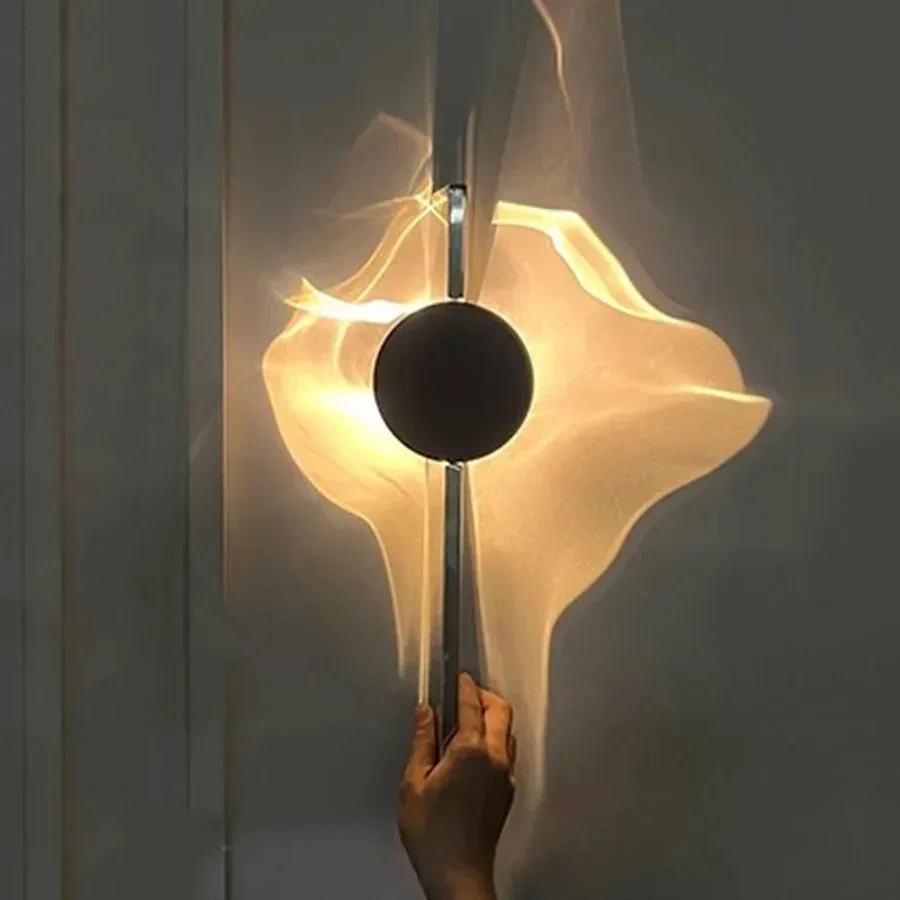Single-head chrome LED wall light creating a warm ripple effect