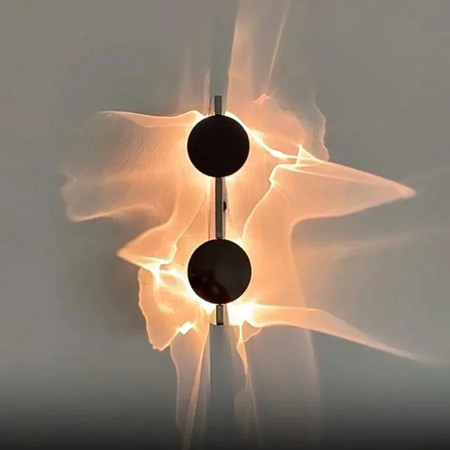 Double-head LED wall light casting warm ripple patterns on a wall