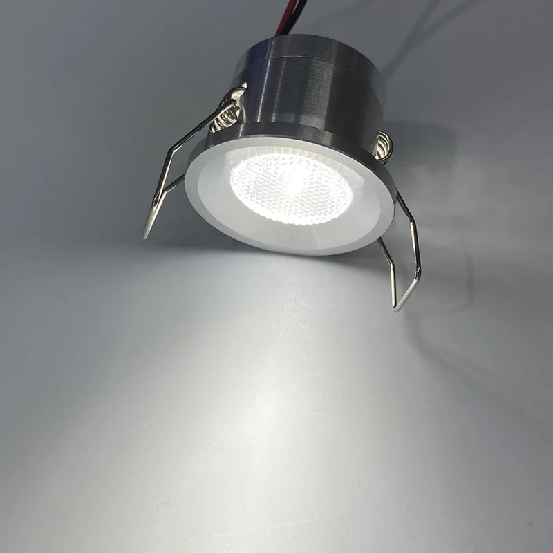 Spring-clip installation of a mini LED downlight in a 27mm cutout