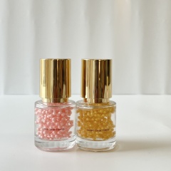 B2B Pink & Golden Caviar Essence combo set—two transparent glass bottles with golden lids, holding pink/golden beaded essences, fit for bulk skincare procurement & OEM/ODM customization
