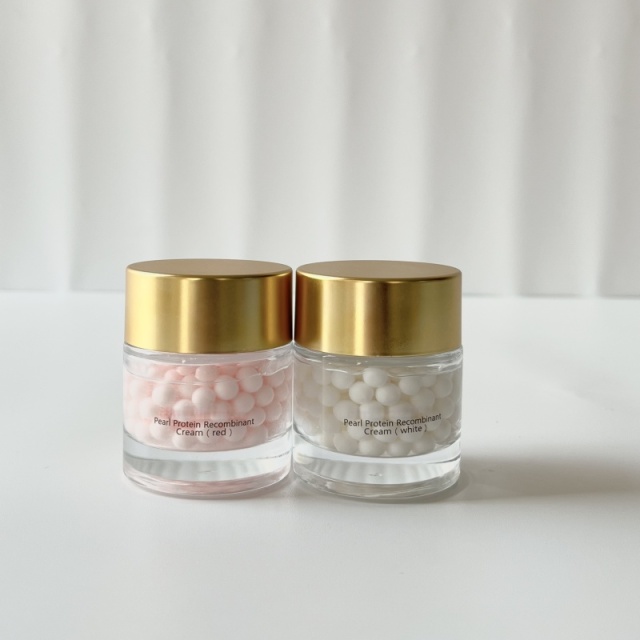 Wholesale Pearl Protein Recombinant Cream (red & white variants) display—two transparent glass jars with golden lids, holding pink/white beaded cream, ideal for B2B skincare sourcing & private label customization