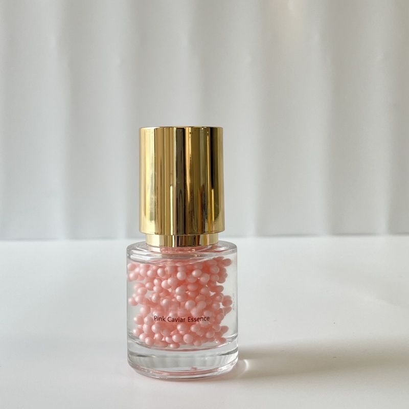 Wholesale Pink Caviar Essence single unit—transparent glass bottle with golden lid, containing pink beaded essence, perfect for B2B skincare wholesale & custom private label packaging