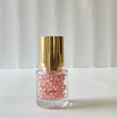 Wholesale Pink Caviar Essence single unit—transparent glass bottle with golden lid, containing pink beaded essence, perfect for B2B skincare wholesale & custom private label packaging
