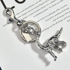 This keychain is shaped like a long-necked dragon and made of brass