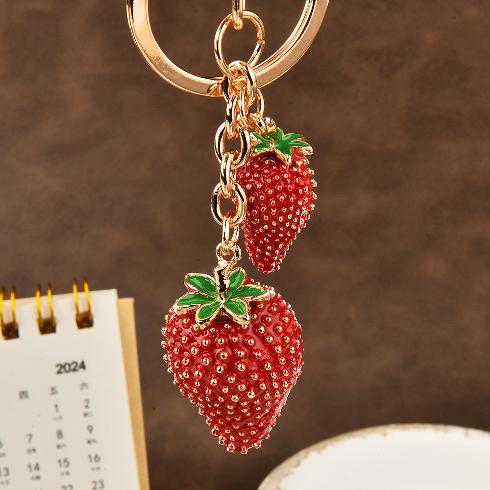 Diamond-encrusted strawberry keychain | Wrap the "Sweet Cool Strawberry" in a hanging bag